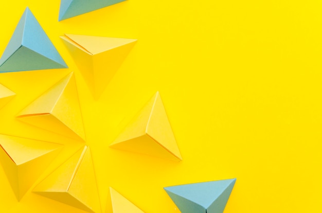 Free Photo flat lay of colorful paper pyramids with copy space