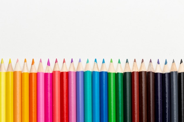 Flat lay of colorful pencils with copy space