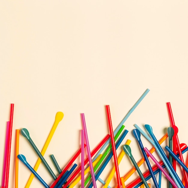 Free photo flat lay colorful plastic straw collection