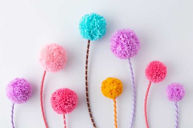 Flat lay colorful pom poms arrangement