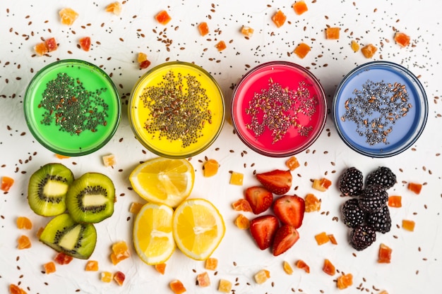 Free photo flat lay colorful smoothies in glasses