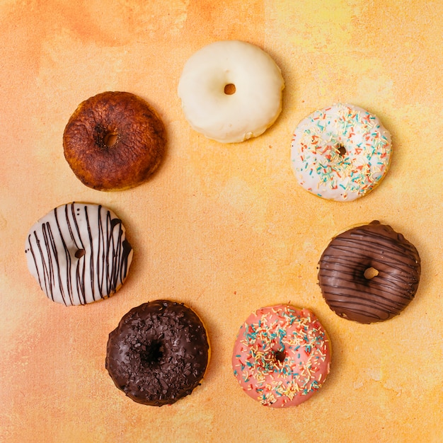 Free photo flat lay composition of tasty donuts