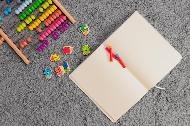 Free photo flat lay composition of toys and open book template