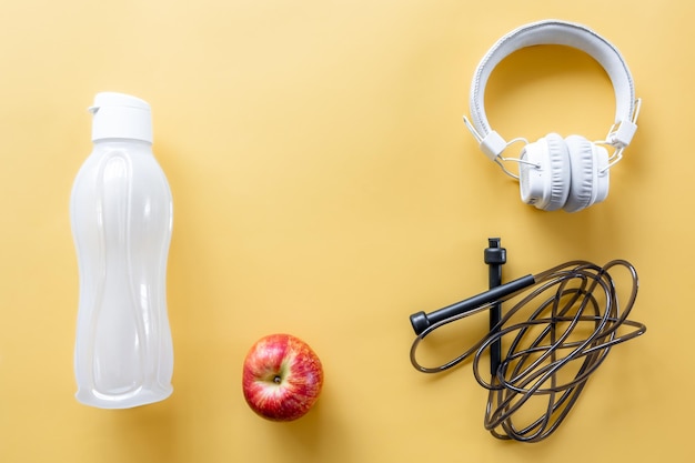 Free photo flat lay composition with sports equipment on yellow background