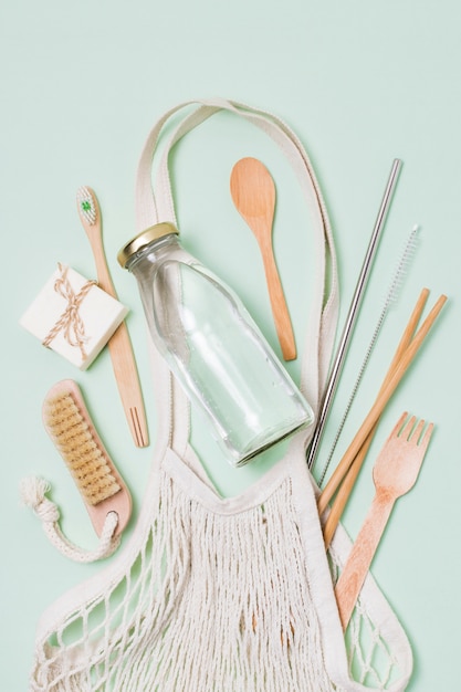 Flat lay composition of zero waste products on green background