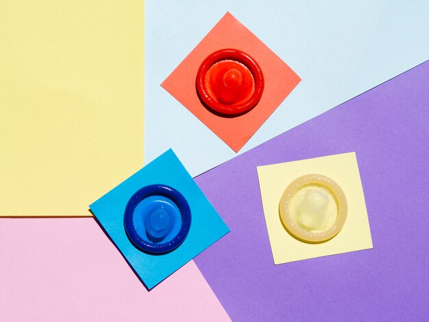 Flat lay condoms on colourful background