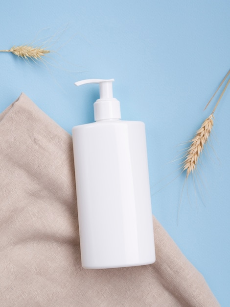 Free Photo flat lay cream bottle mock-up next to wheat