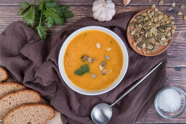 Flat lay cream soup with slices of bread