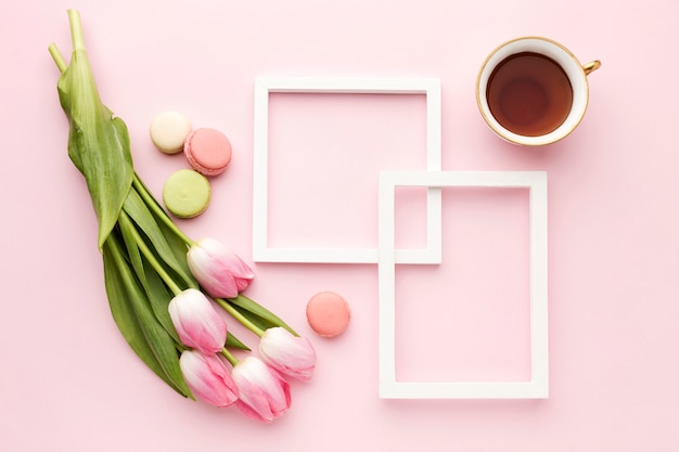 Flat lay cup with tulips beside