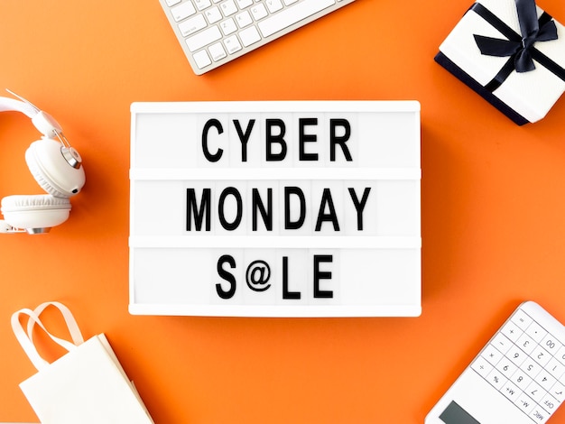 Free photo flat lay of cyber monday light box with gift and shopping bag