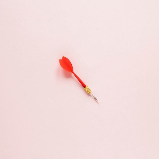 Flat lay darts arrow on pink background