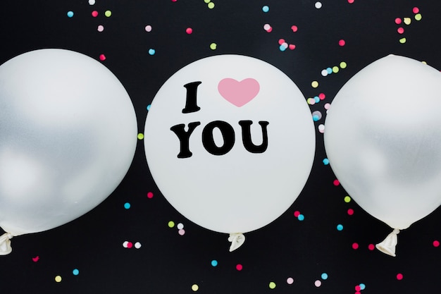 Flat lay decoration with balloons and black background