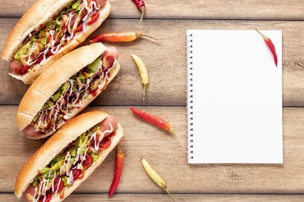 Free photo flat lay decoration with hot dogs and peppers