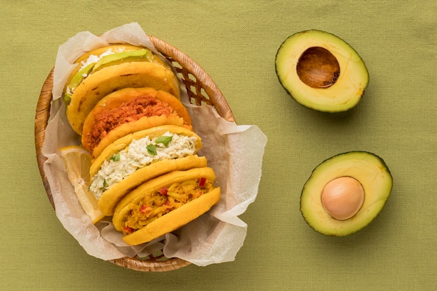 Flat lay delicious arepas and avocado