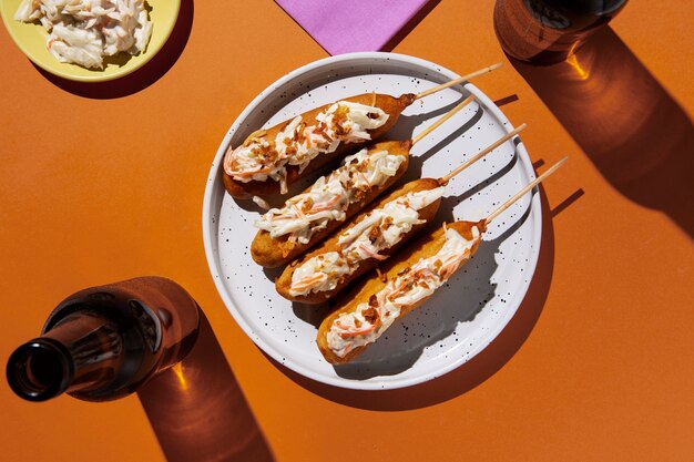 Flat lay delicious corn dogs on plate