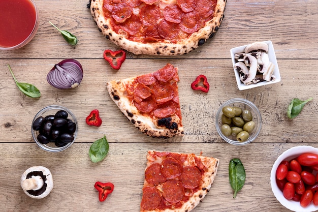 Flat lay delicious pizza on wooden background