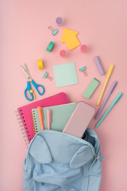 Flat lay desk arrangement with backpack