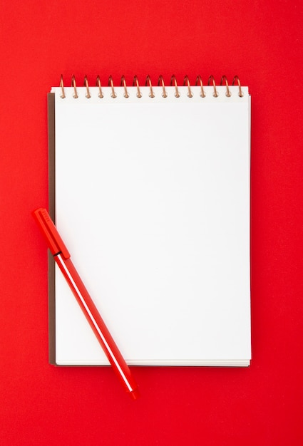 Flat lay desk arrangement with empty notepad