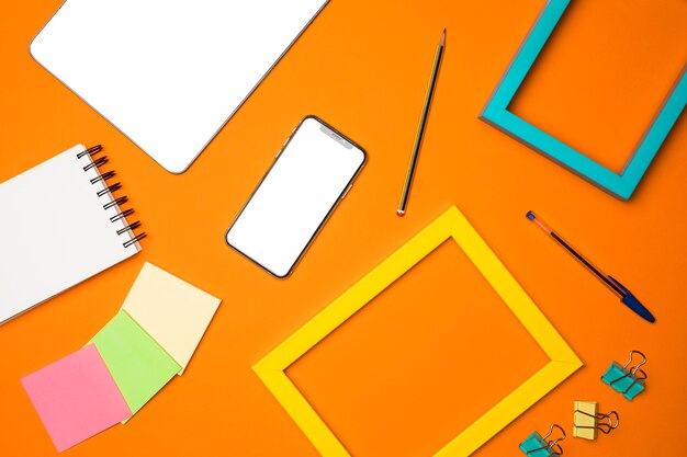 Flat lay desk concept with orange background