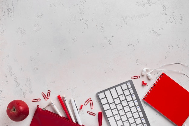 Free Photo flat lay of desk with apple and keyboard