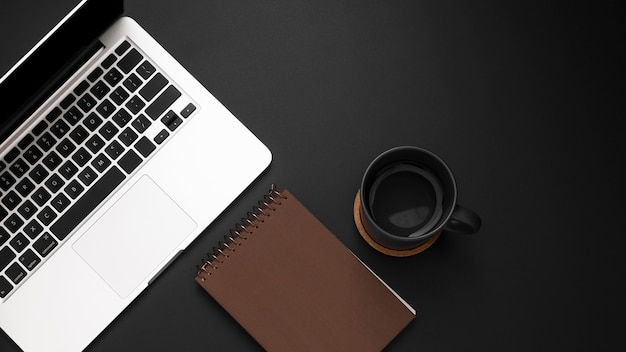 Free Photo flat lay of desktop with laptop and cup of coffee