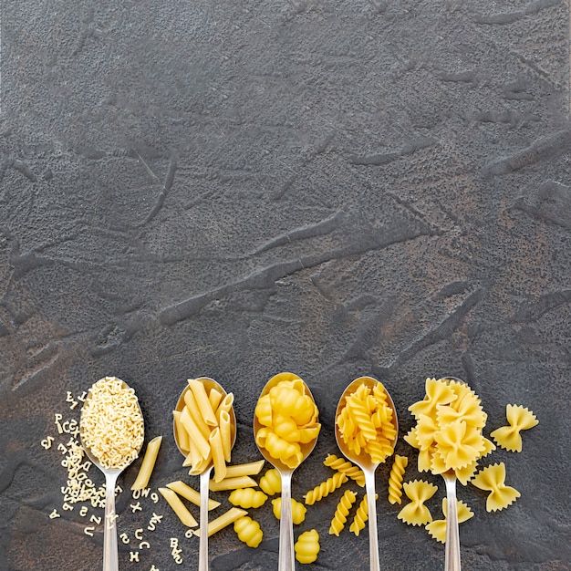 Free photo flat lay of different types of pasta with copy space