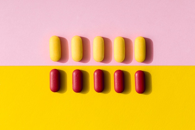 Free Photo flat lay of differently colored pills in rows