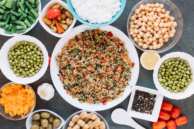 Flat lay of dishes with chickpeas and black pepper