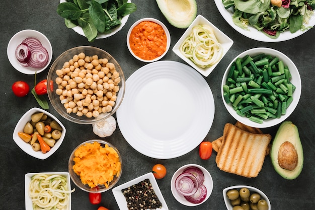 Flat lay of dishes with green beans and avocado