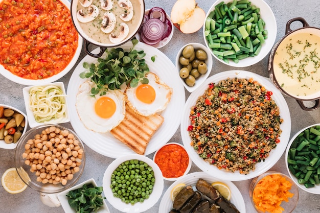 Flat lay of dishes with olives and fried eggs