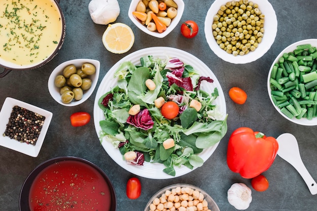 Flat lay of dishes with salad and cherry tomatoes