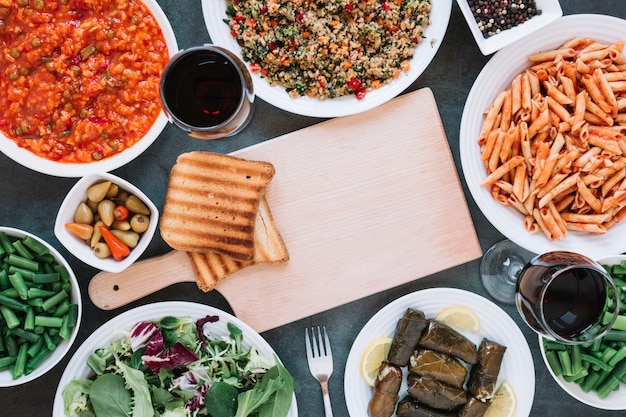 Flat lay of dishes with wine and pasta