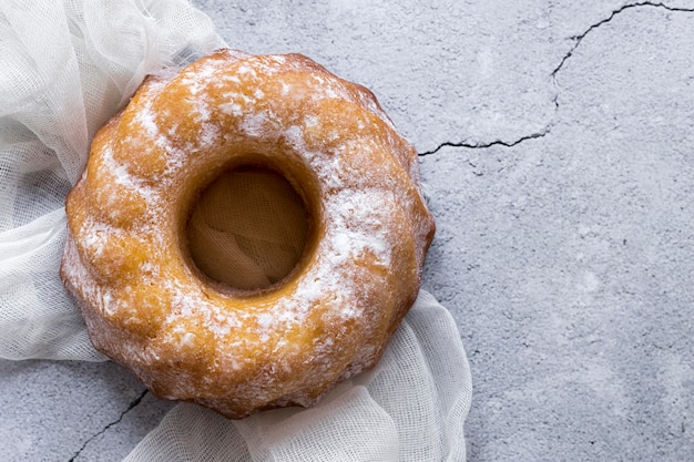 Free Photo flat lay of donut on concrete surface with textile