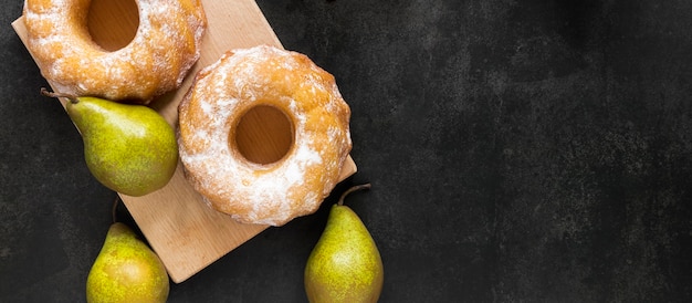 Flat lay of doughnuts with pears and copy space