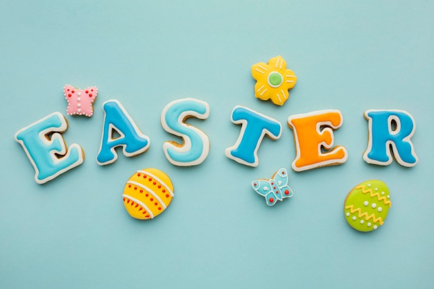 Flat lay of easter eggs with flower and butterfly shapes