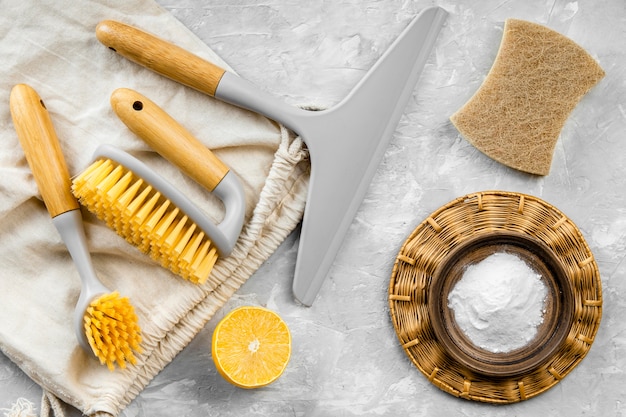 Free photo flat lay of eco-friendly cleaning products with brushes and baking soda