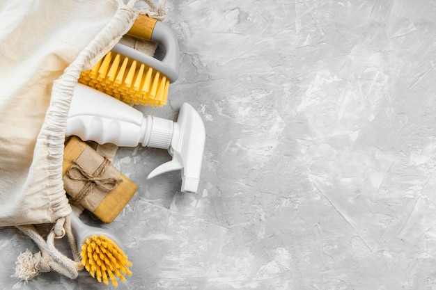 Free photo flat lay of eco-friendly cleaning products with brushes and copy space