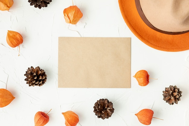 Free Photo flat lay empty envelope with pine cones