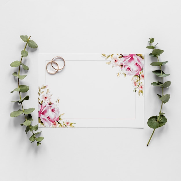 Free photo flat lay engagement rings and branches