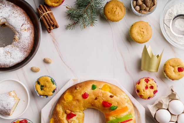 Flat lay of epiphany day dessert with crown and cinnamon