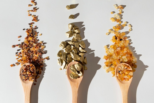 Free Photo flat lay of epiphany day raisins and stones in wooden spoons