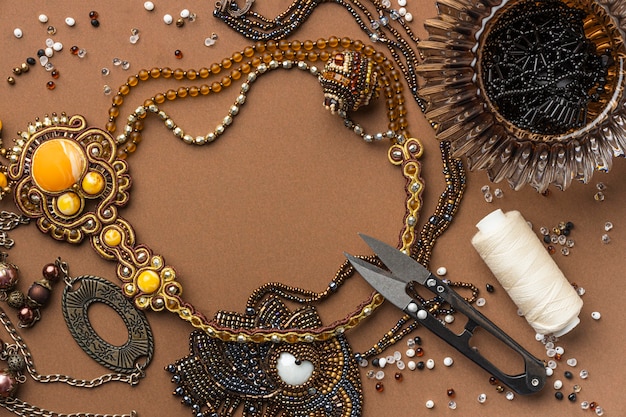 Free photo flat lay of essentials for bead working with scissors