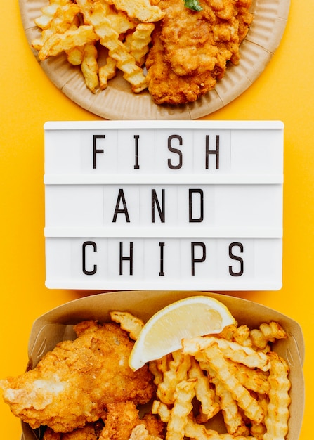 Free photo flat lay of fish and chips with light box and sauce