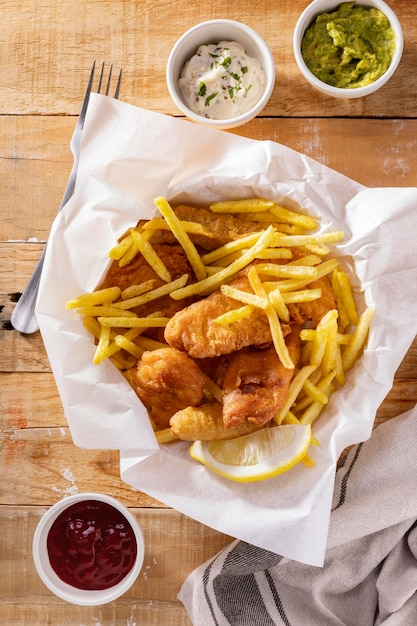 Free photo flat lay of fish and chips with sauces