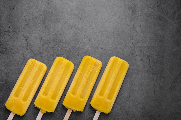 Free photo flat lay flavored ice cream on stick