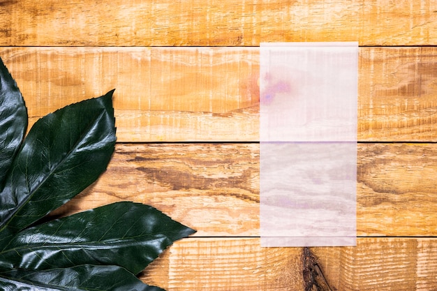 Free photo flat lay flimsy paper with wooden background