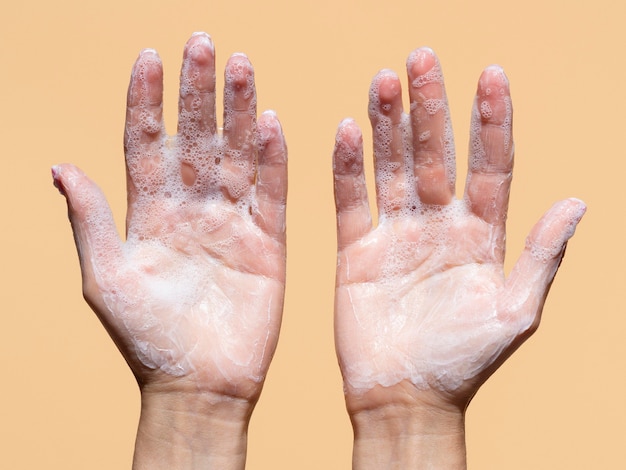 Flat lay of foamy hands from soap