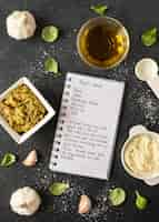 Free photo flat lay of food ingredients with notebook and oil