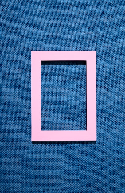 Free photo flat lay frame on blue background