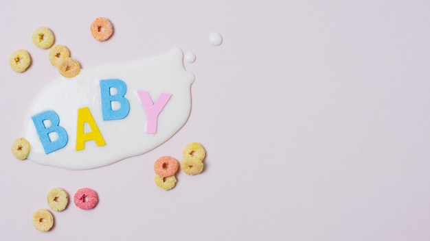 Flat lay frame with baby word, milk and cereals